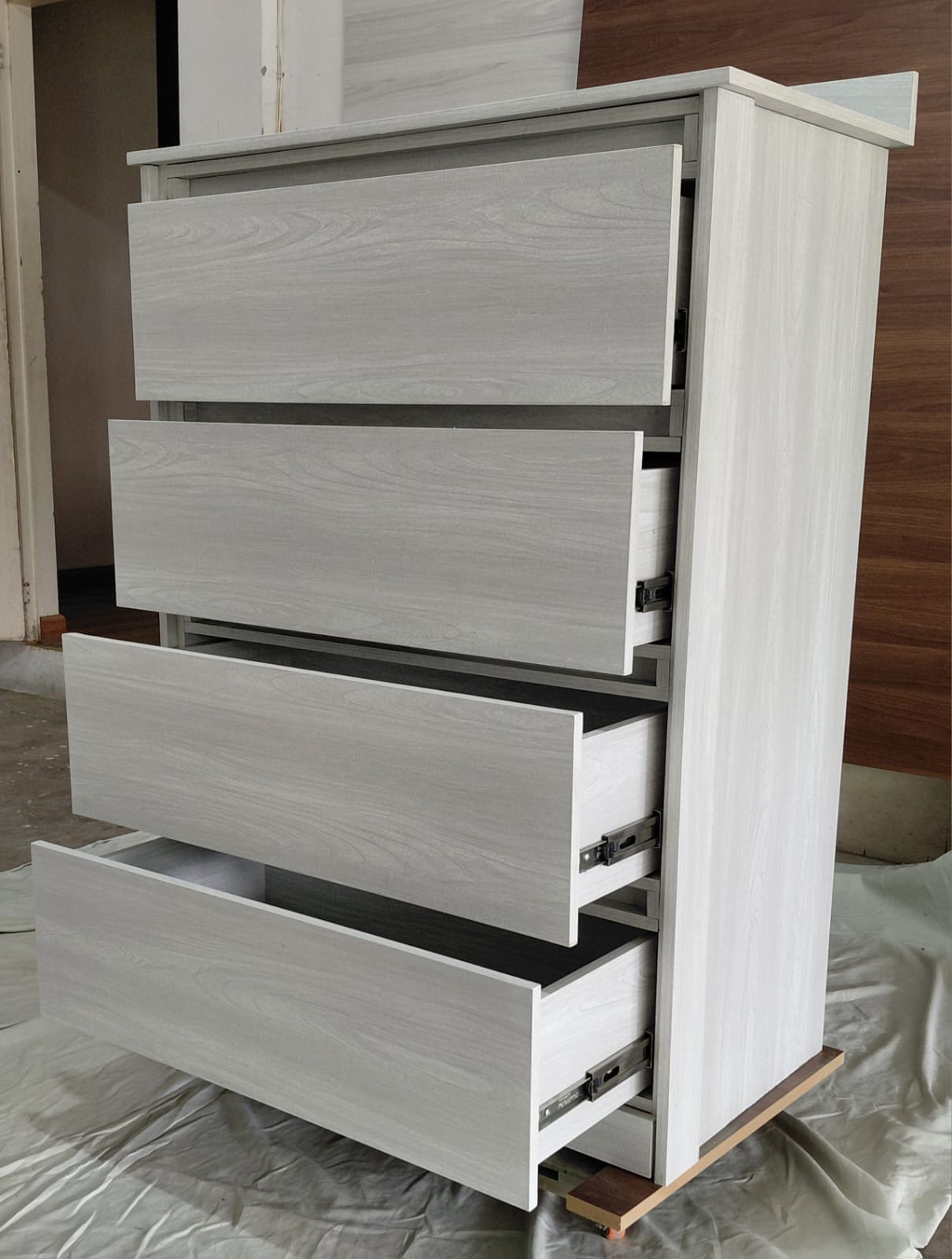 Gray woodgrain chest of drawers with drawers open