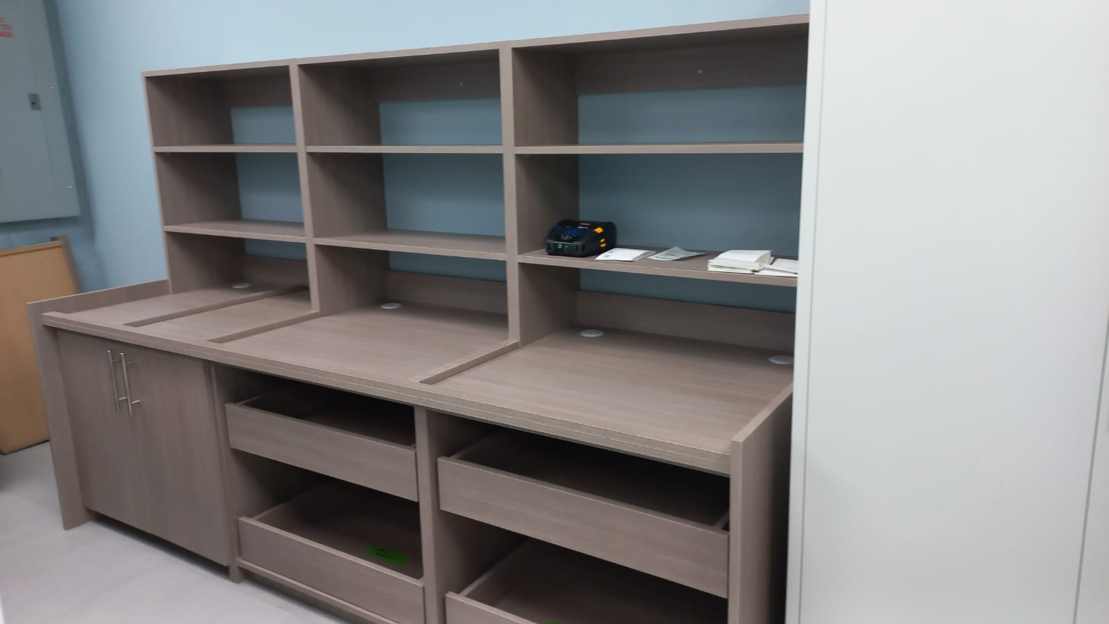 Office shelving and storage wall with open cubbies and drawers