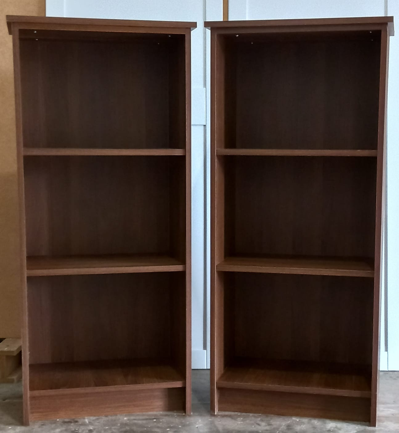 Pair of walnut-finish three-shelf bookcases