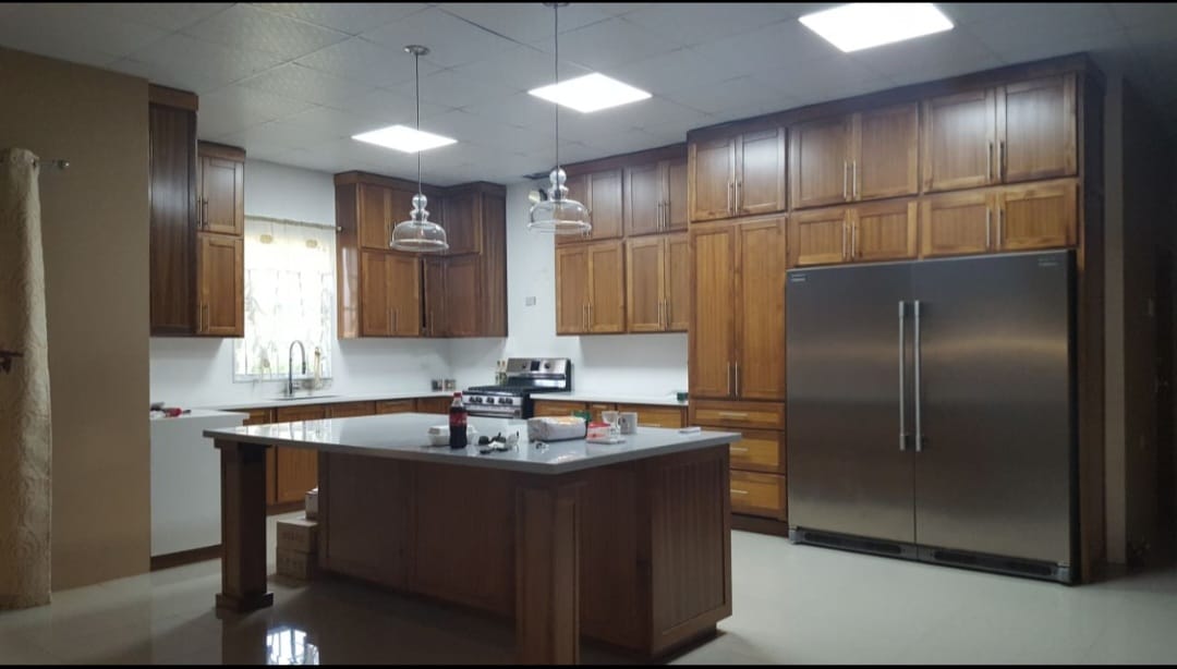 Full kitchen remodel with warm walnut cabinetry and island