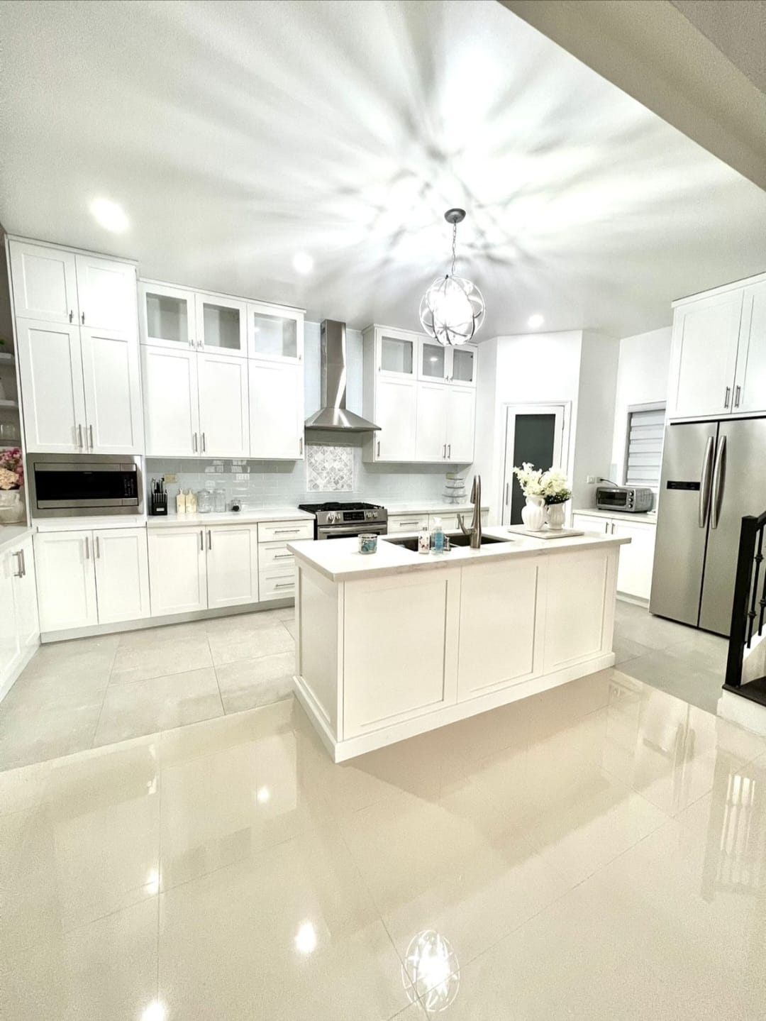Full kitchen remodel with white shaker cabinetry and island