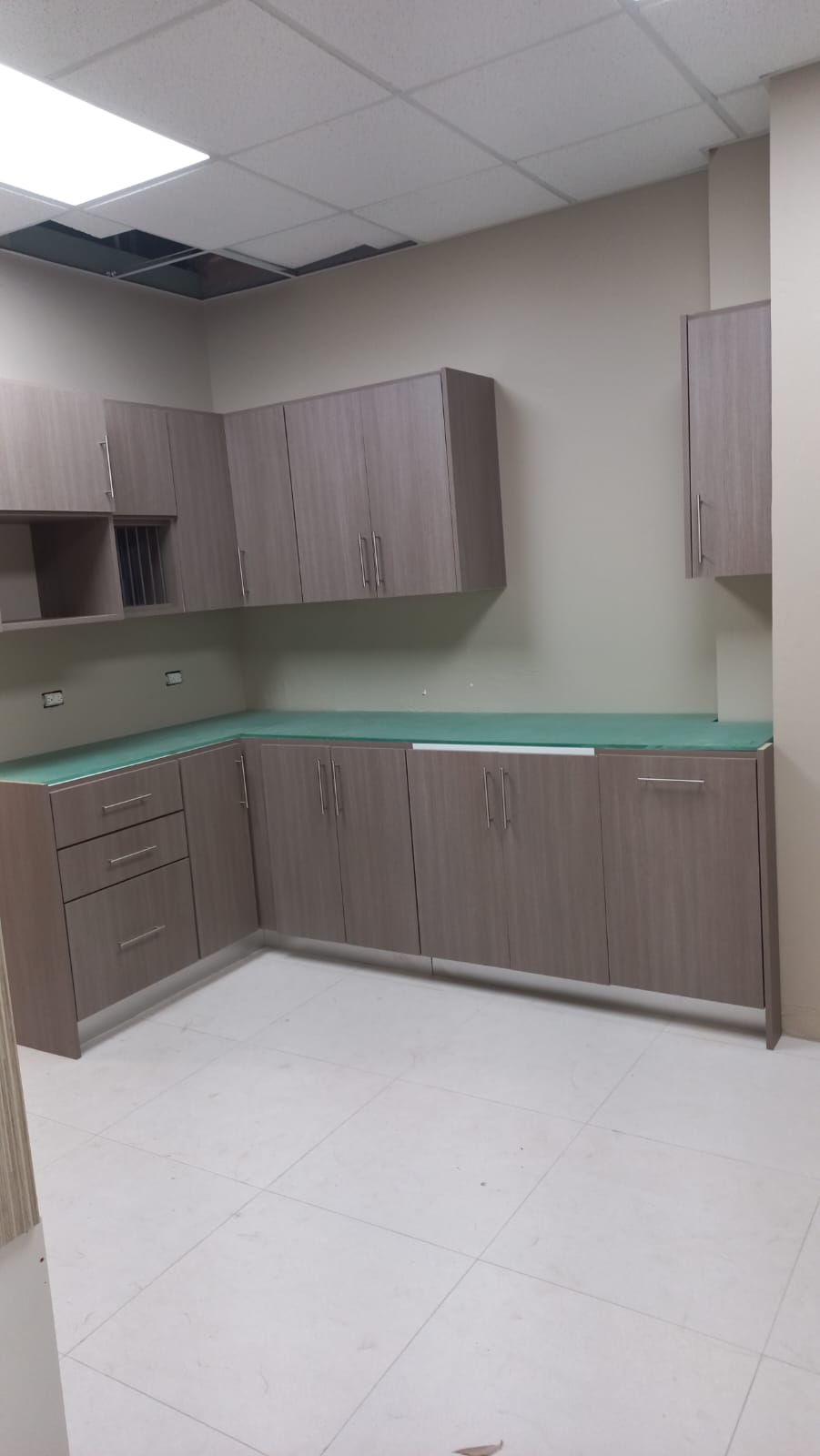 L-shaped office break room cabinetry with upper and lower cabinets